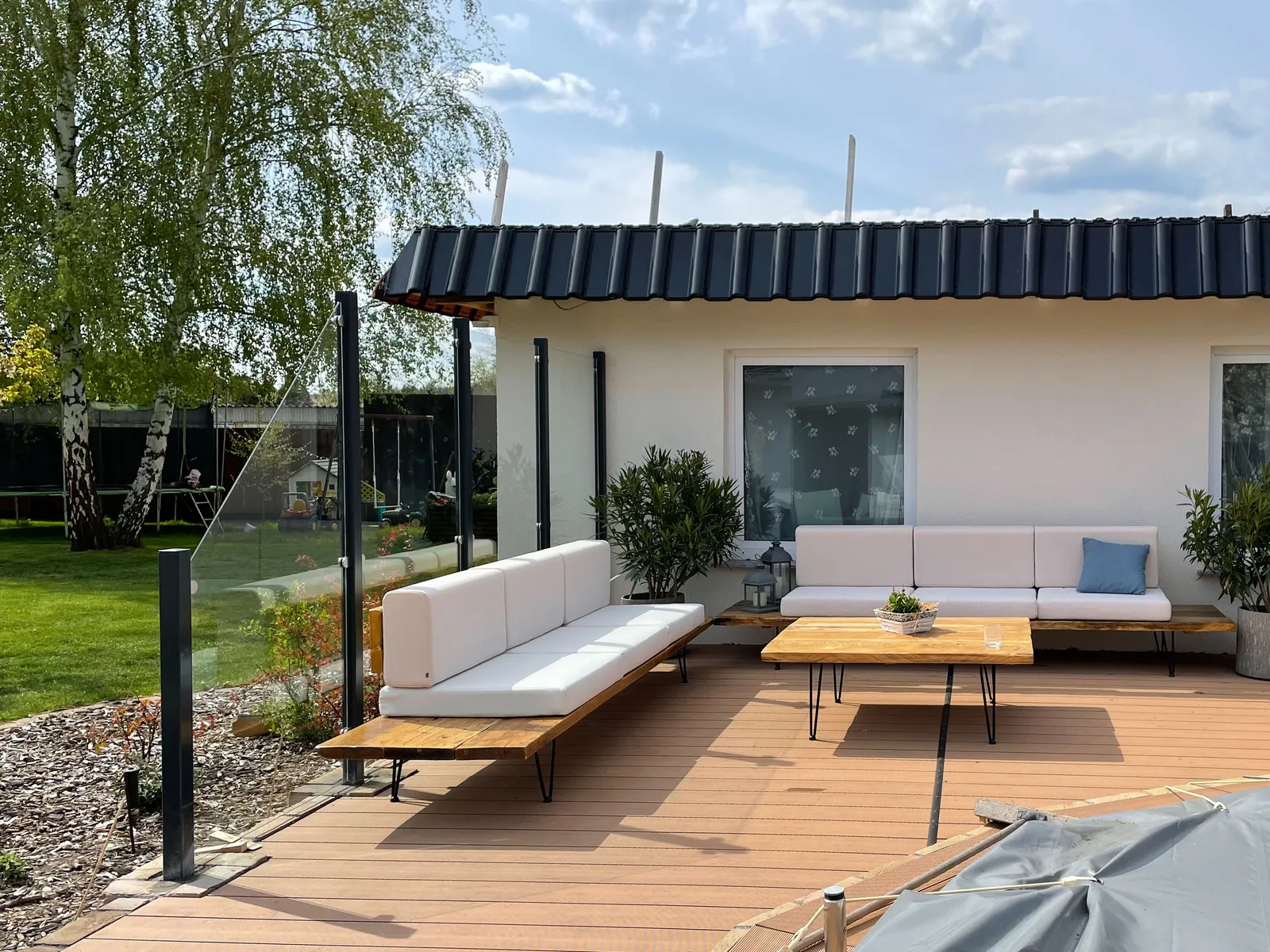 Windschutz aus Klarglas auf der Terrasse an einer Lounge